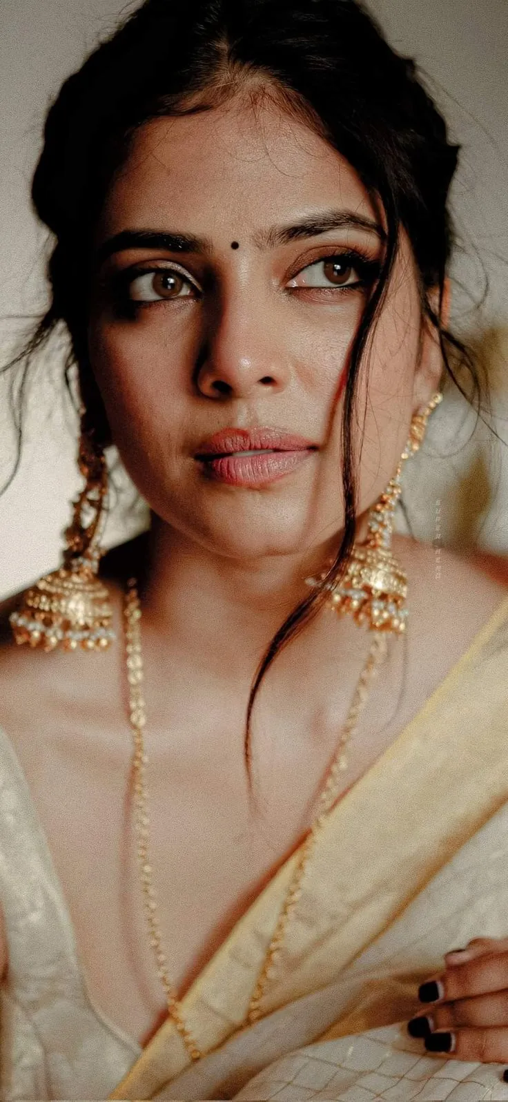 Charming Malavika Mohanan Side Pose Wearing Golden Outfit
