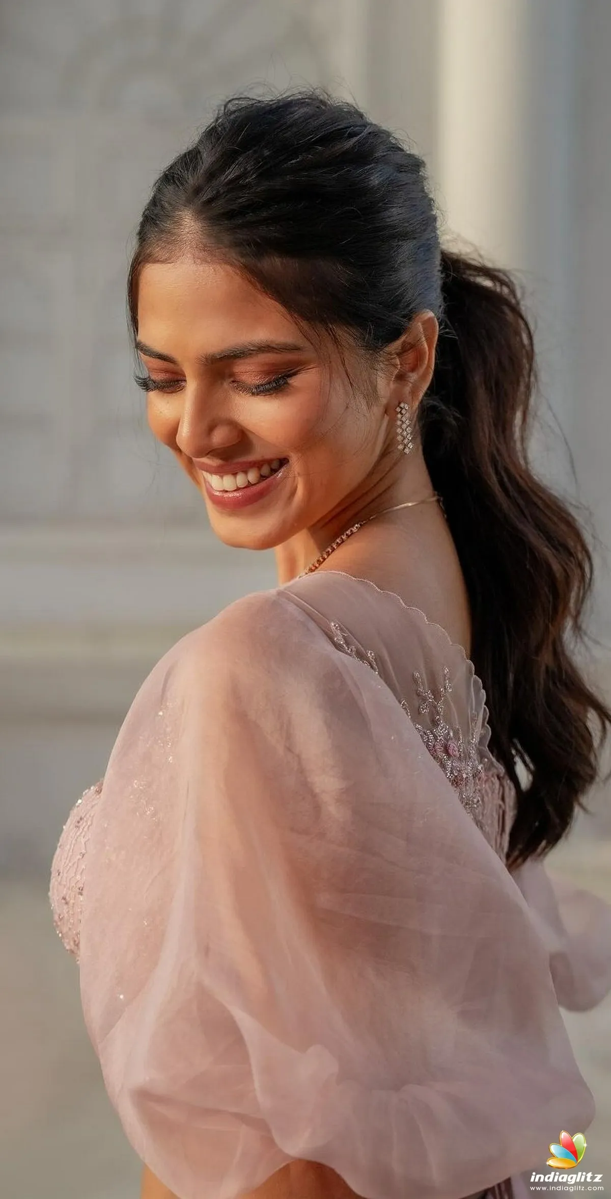Charming Malavika Mohanan Smiling Wearing Pink Outfit Image