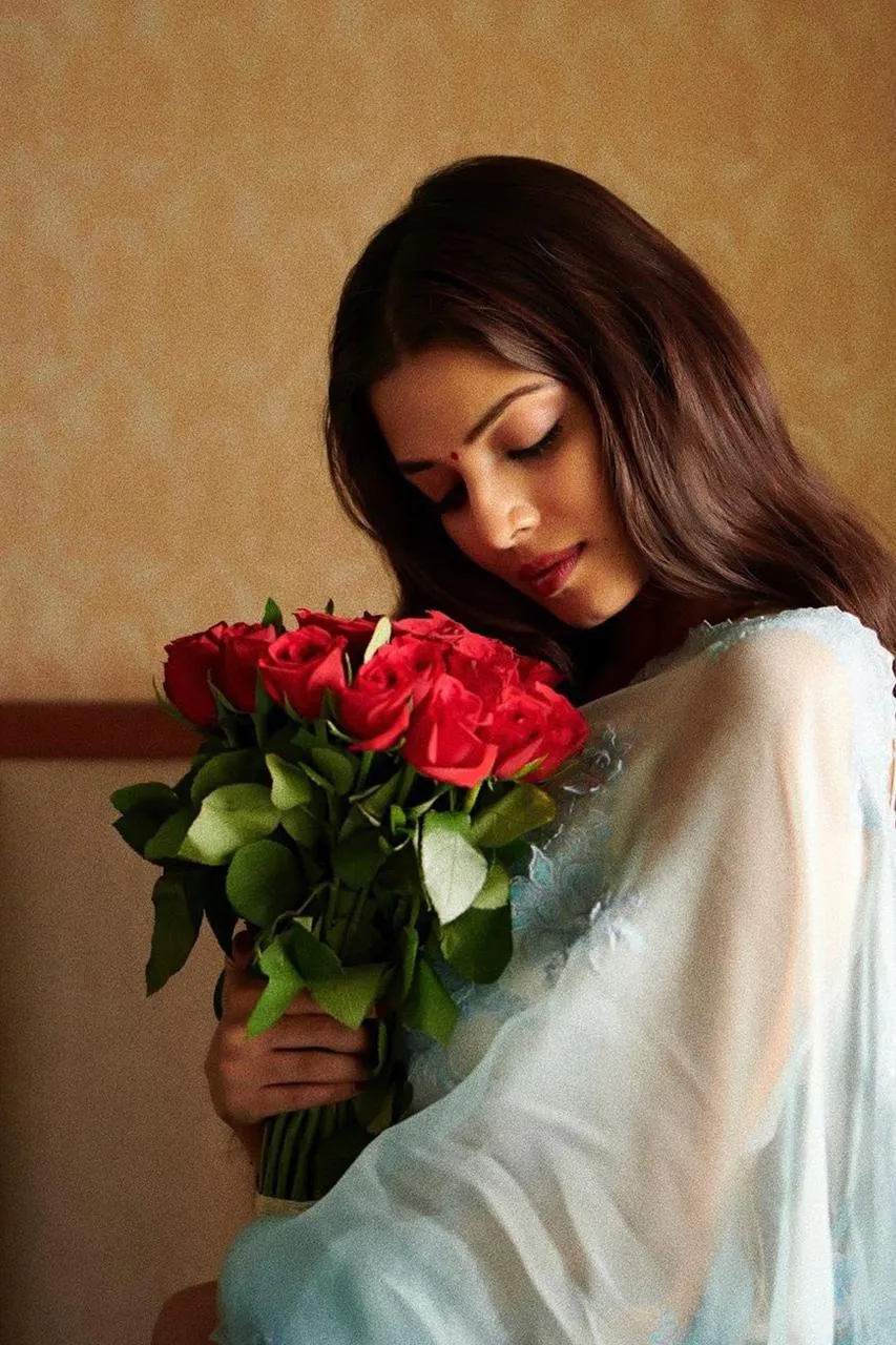 Charming Photo of Malavika Mohanan Holding a Red Flower