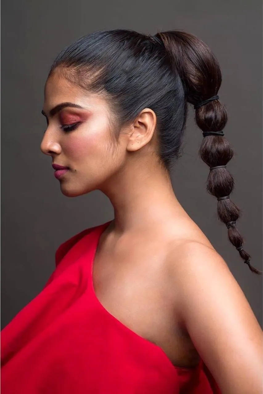 Elegant Pose of Malavika Mohanan Graceful in Red Gown Image