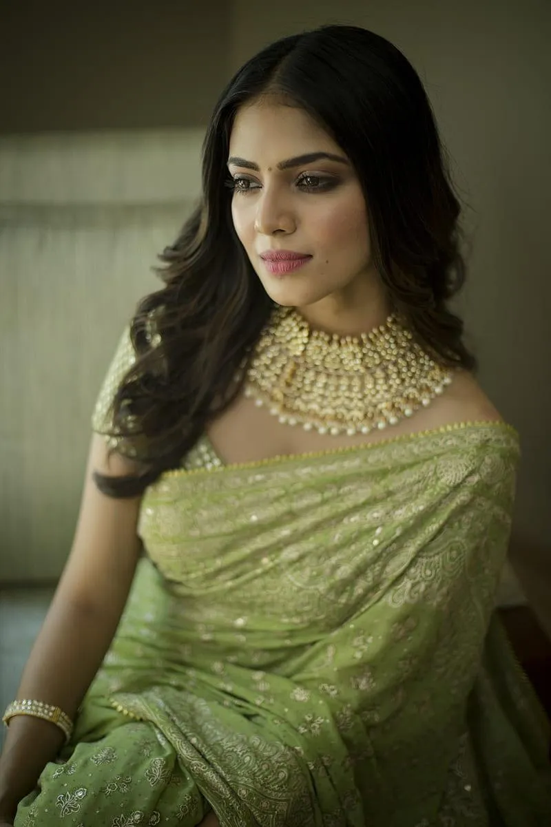 Glamorous Shot of Malavika Mohanan Chic Pose in Green Saree