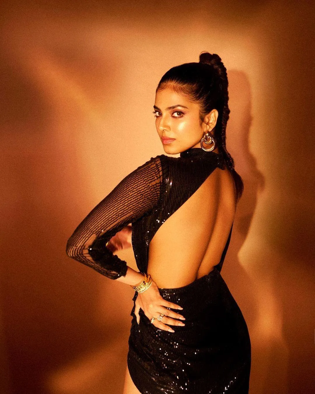 Glamour Pic of Malavika Mohanan Bold Pose in Golden Attire