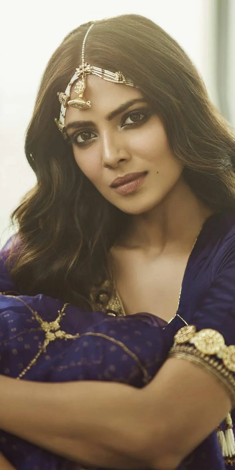 Glamour Pic of Malavika Mohanan Calm Pose in Golden Dress