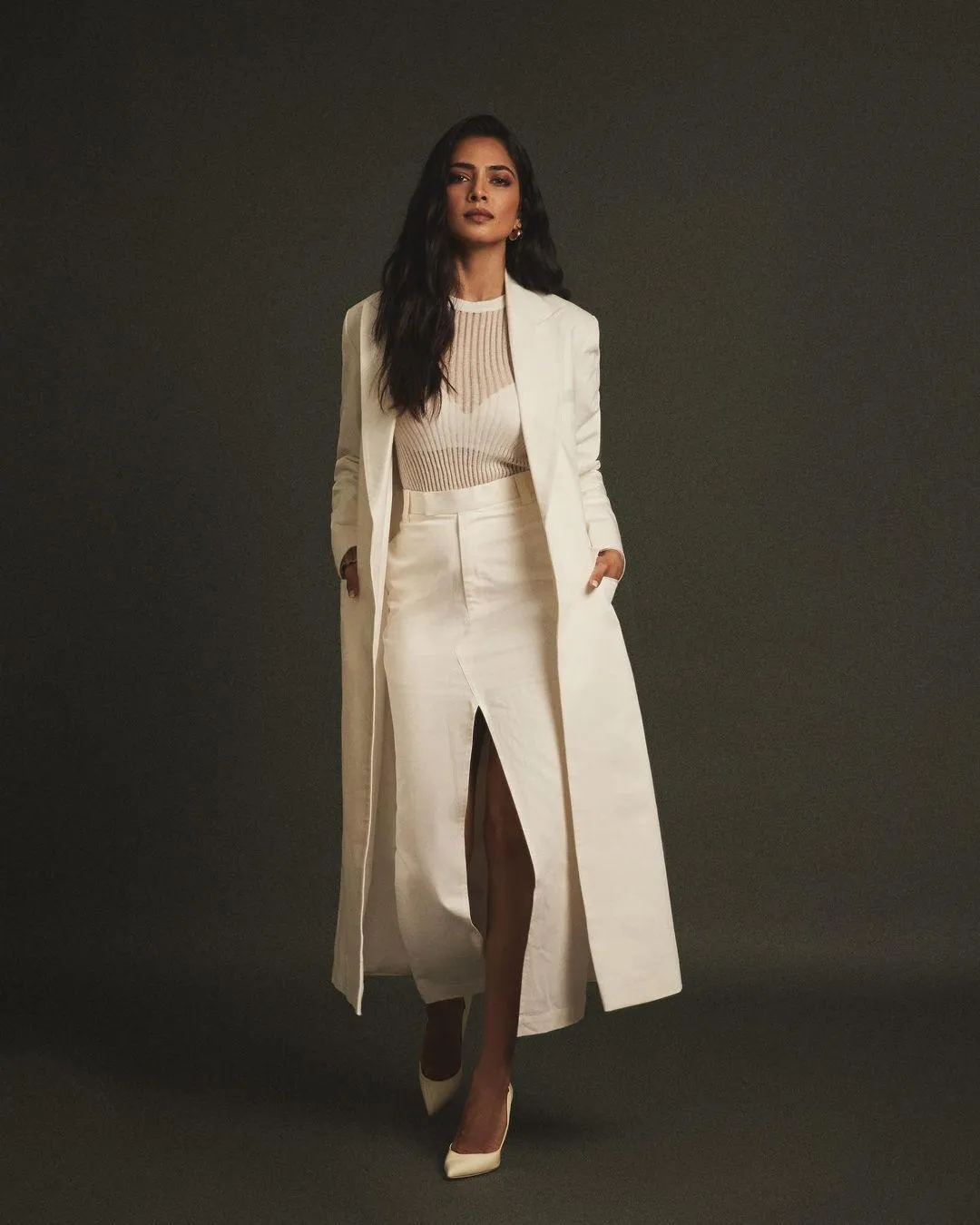 Glamour Pic of Malavika Mohanan Elegant Pose in White Dress