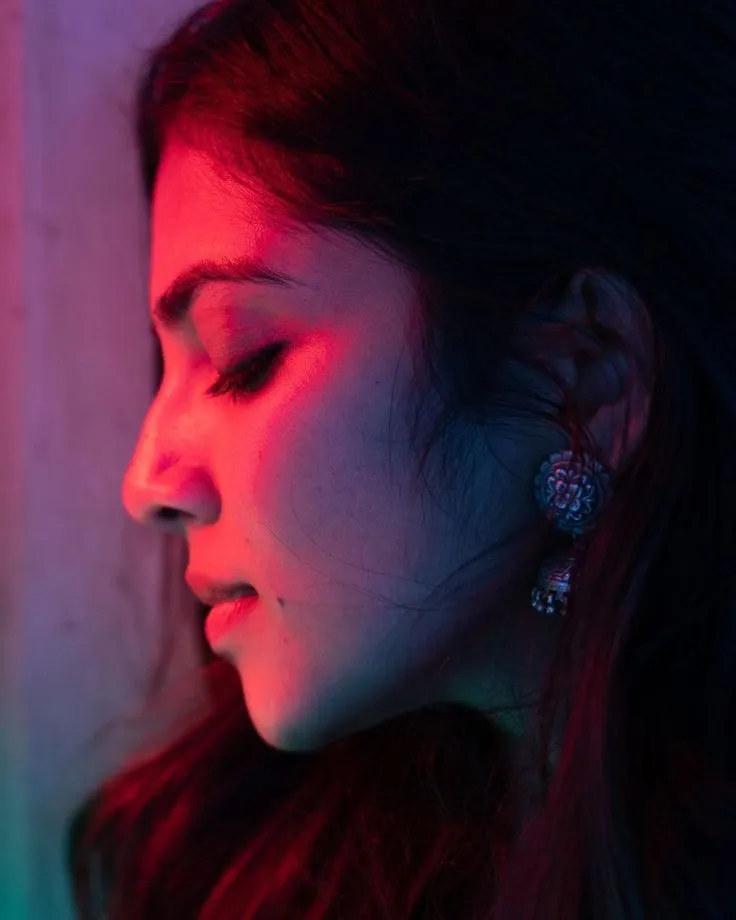 Gorgeous Malavika Mohanan Red Light Side Pose with Elegance