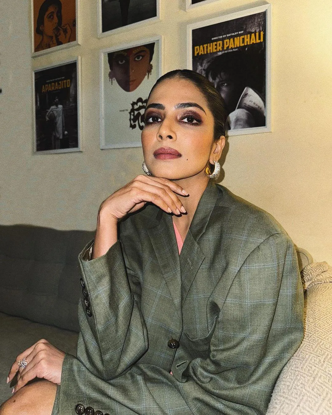 Handsome Malavika Mohanan in Olive Green Shirt Seated Pose