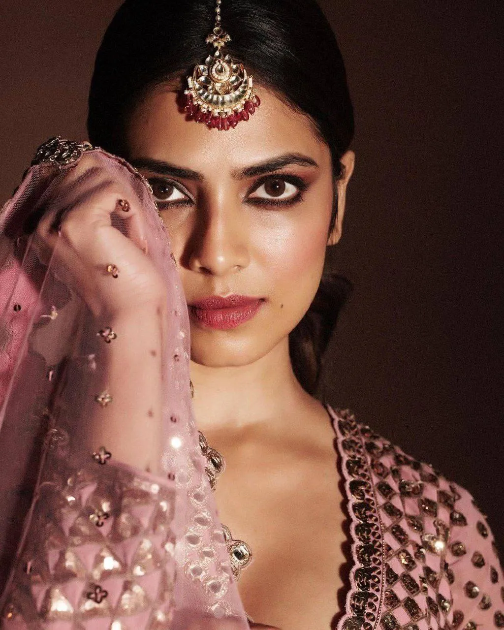 Handsome Malavika Mohanan in Pink Lehenga Stylish Portrait