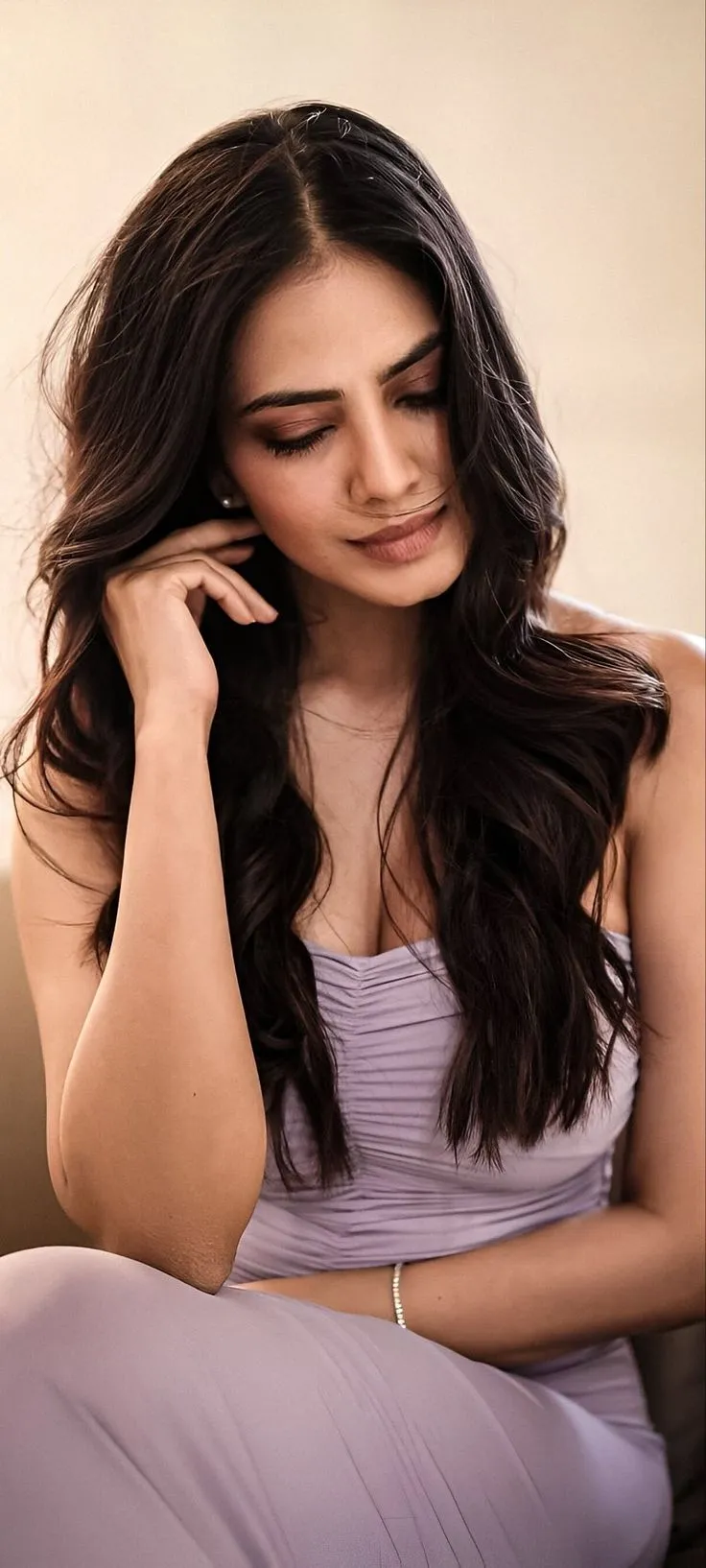 Handsome Malavika Mohanan Seated in Sleeveless Modern Top