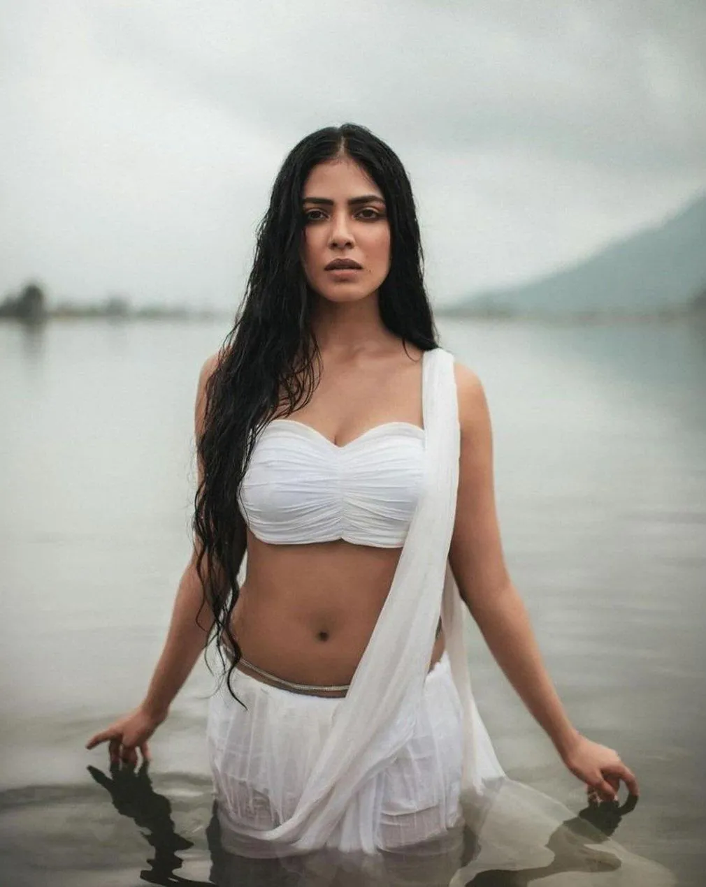 Handsome Malavika Mohanan Wearing White Outfit by the Sea