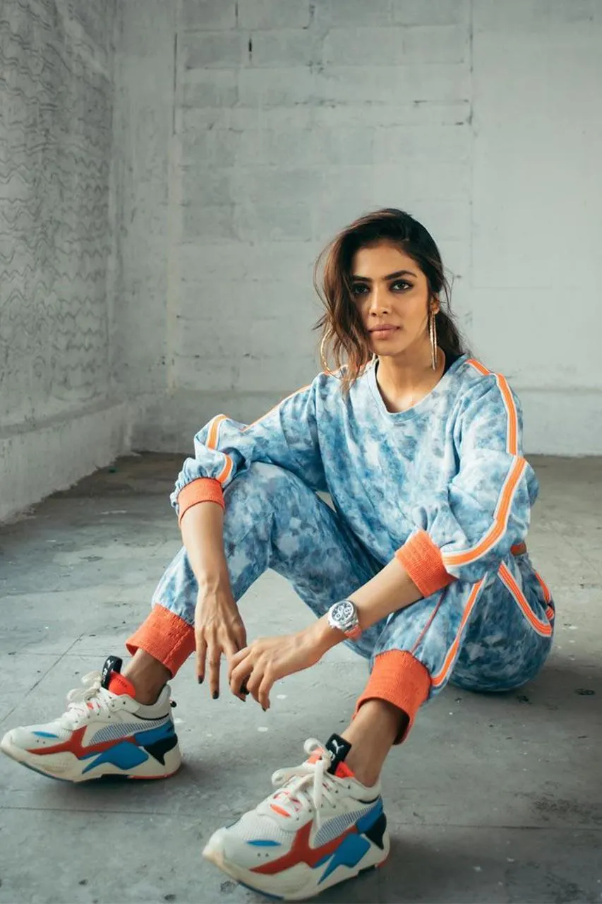 Hot Image of Malavika Mohanan Casual Pose in White Dress