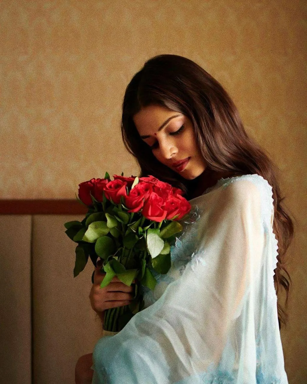 Hot Malavika Mohanan in White Dress Holding Red Flowers