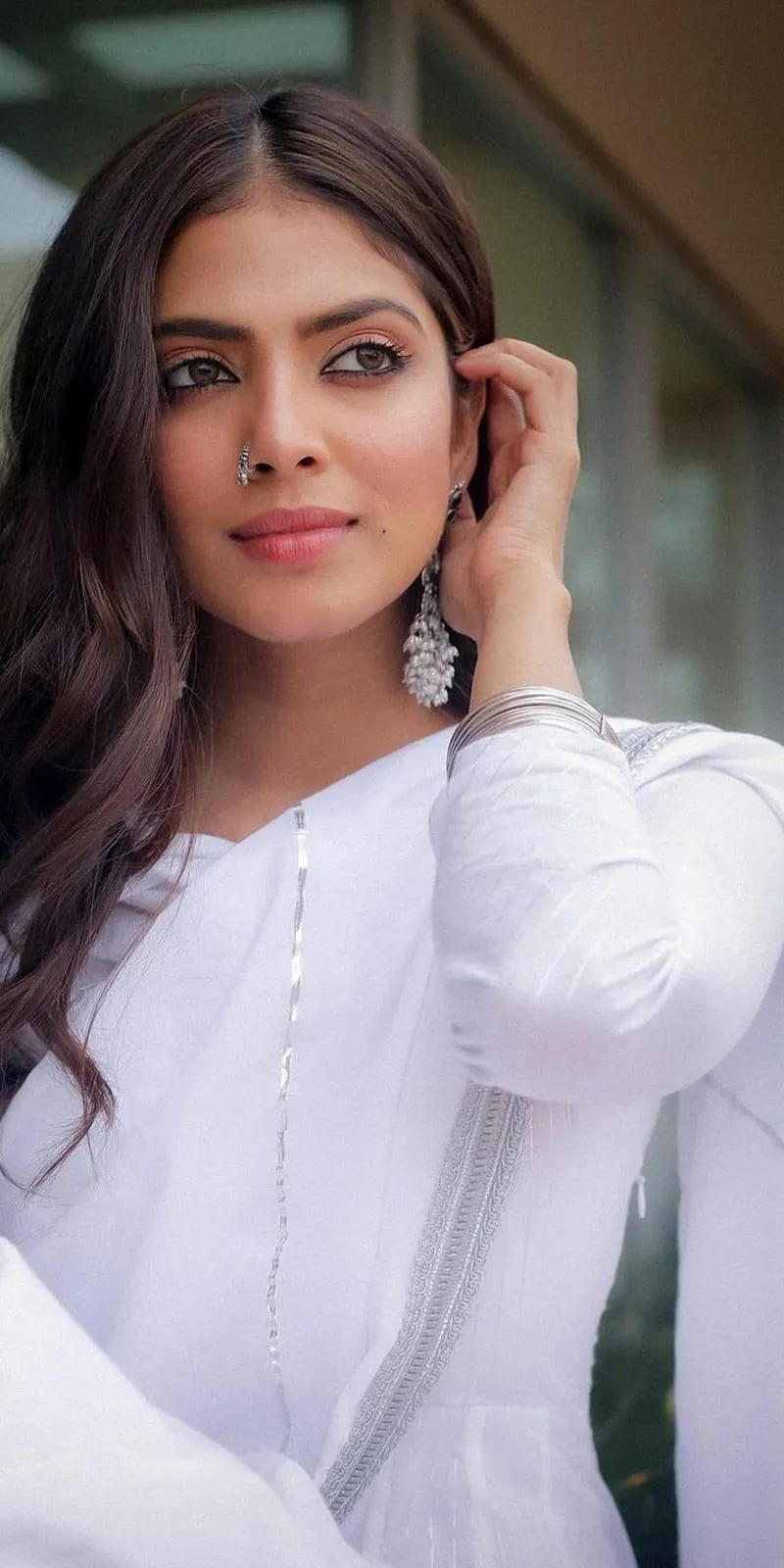Hot Malavika Mohanan in White Outfit Smiling by Window Image