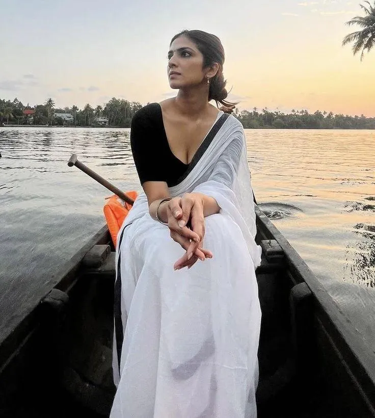 Hot Malavika Mohanan in White Saree Riverside Sitting Pose