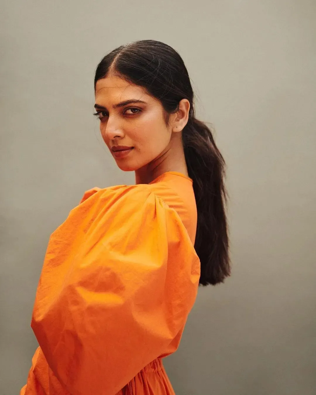 Hot Malavika Mohanan Smiling in Stylish Orange Outfit Image
