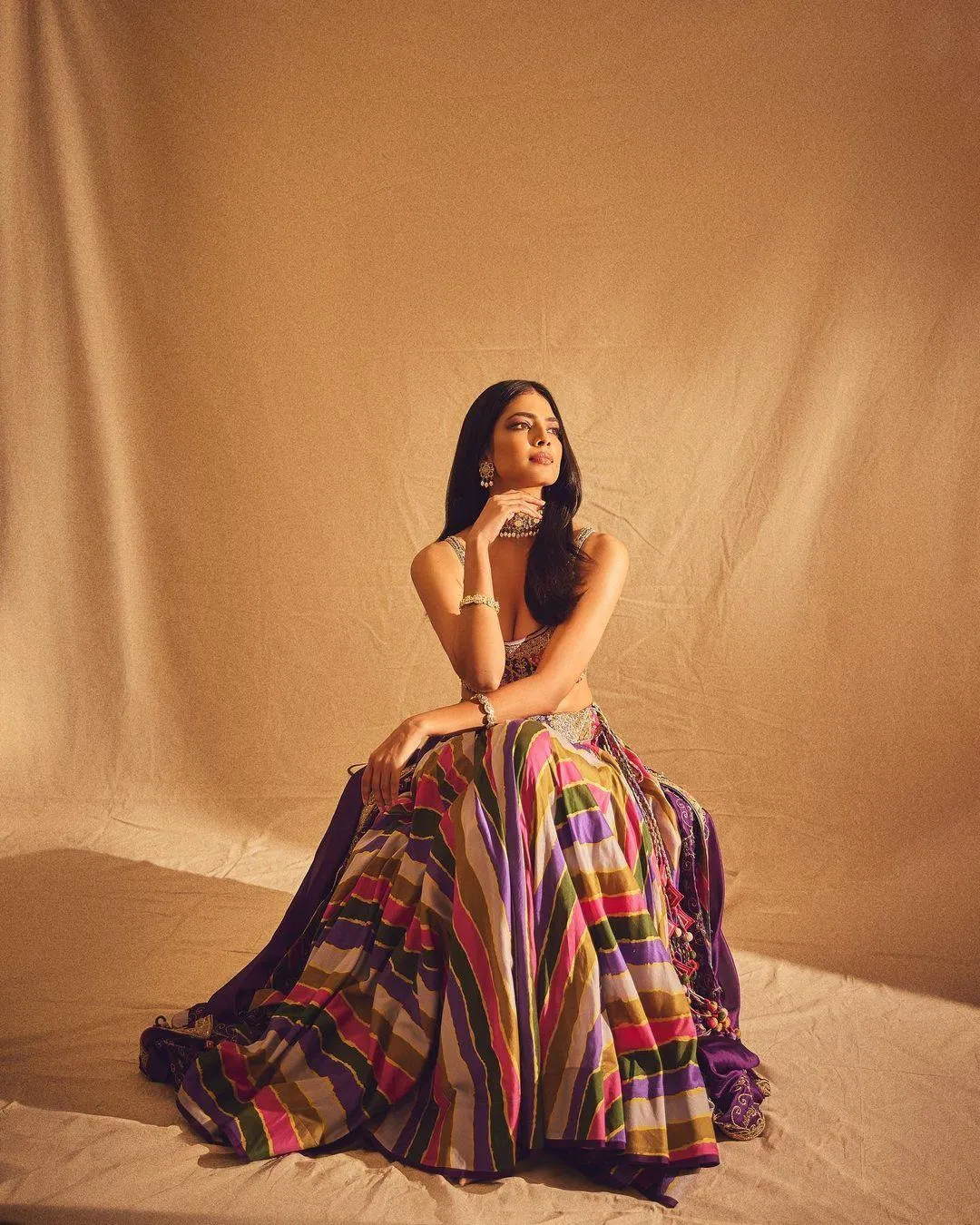 Hottie Malavika Mohanan in Colorful Gown Sitting Pose