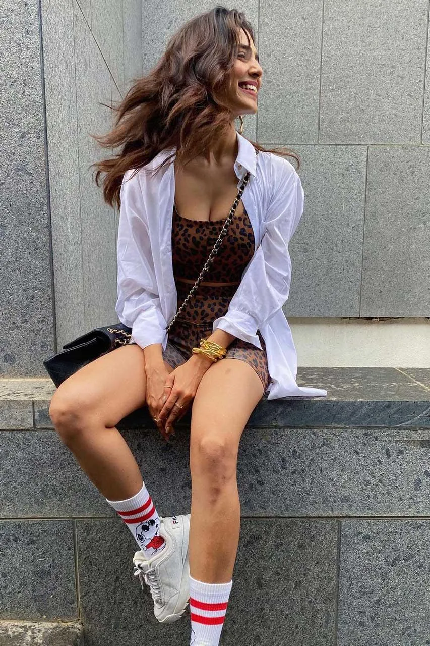 Malavika Mohanan Charming Sitting Casual Look on Steps Image