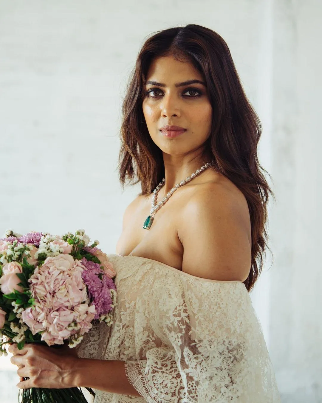 Malavika Mohanan Holding Beautiful Attractive Flowers Image