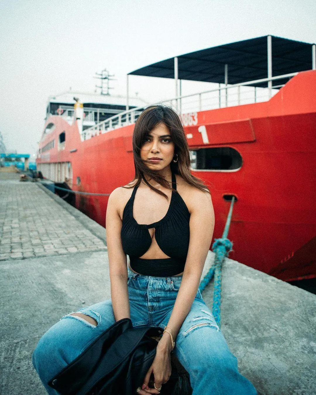 Malavika Mohanan Sitting Near Red Car in Modern Outfit Look