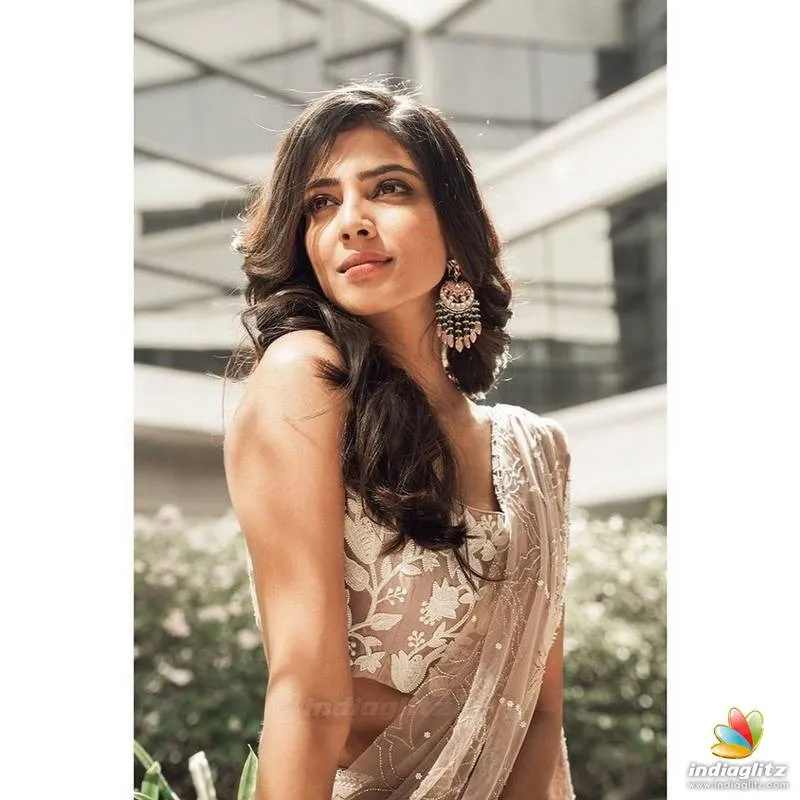 Sensual Malavika Mohanan in Elegant White Dress Pose Image