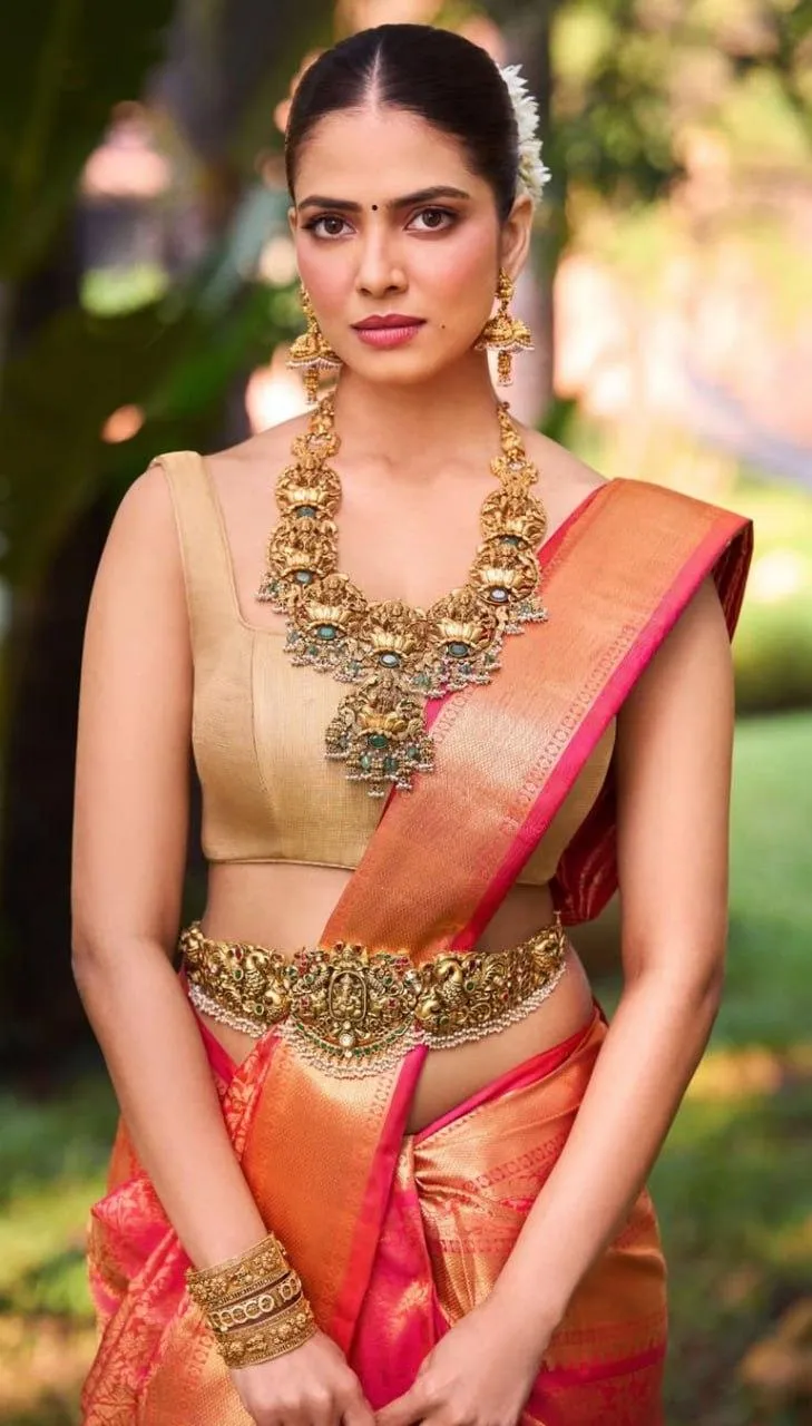 Sensual Malavika Mohanan in Red Silk Saree Traditional Pose