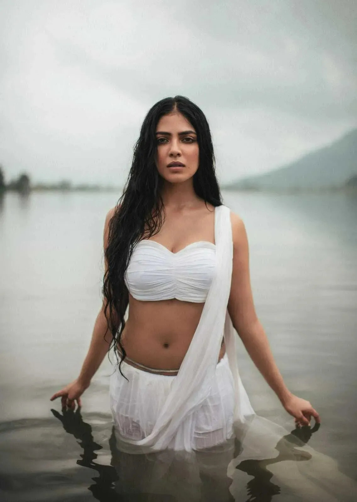 Sensual Malavika Mohanan Posing in White Flowy Gown Image