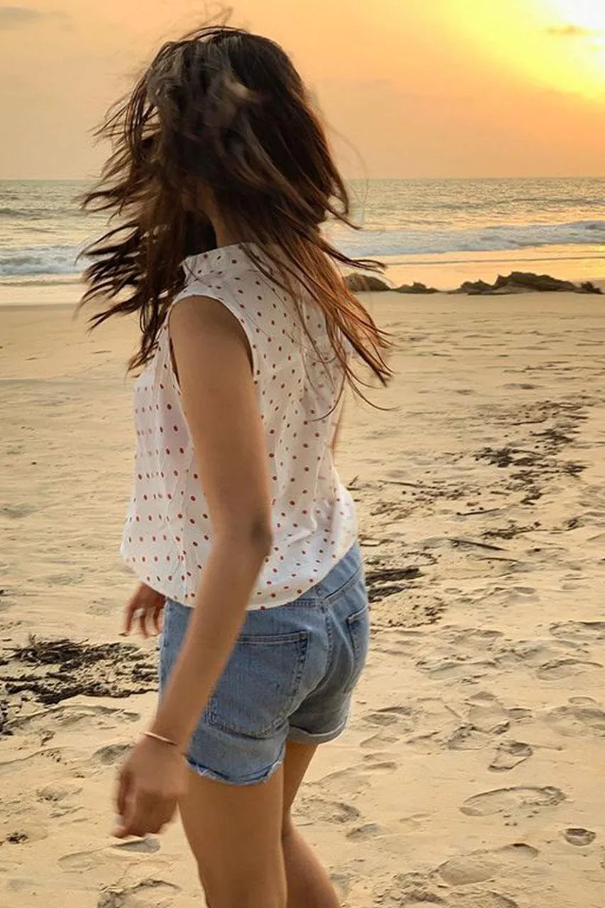 Stunning Malavika Mohanan in Golden Beach Sunset Pose Image