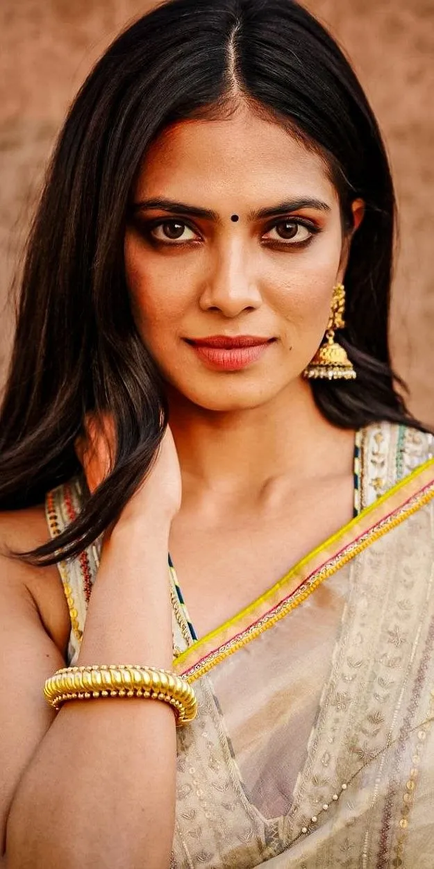 Stunning Malavika Mohanan in Golden Saree Side Angle Pose
