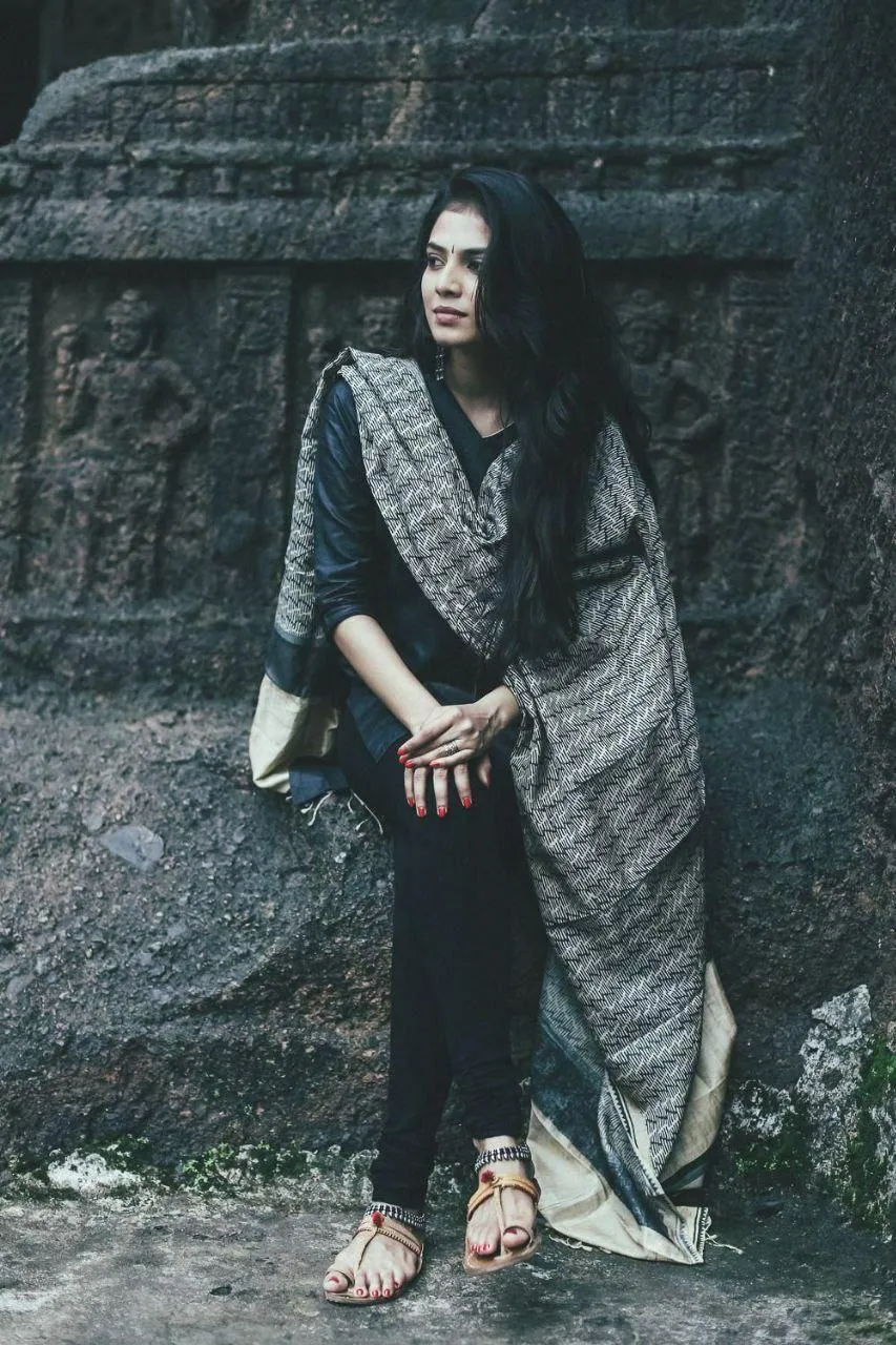 Stunning Malavika Mohanan in Grey Saree Sitting on Stone