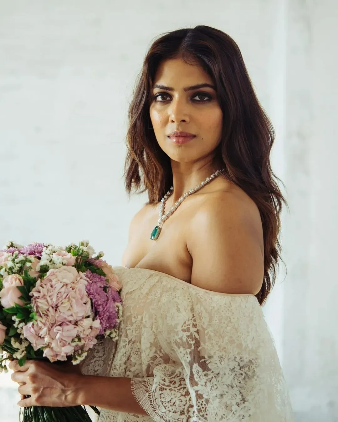 Stunning Malavika Mohanan in White Dress Holding Flowers