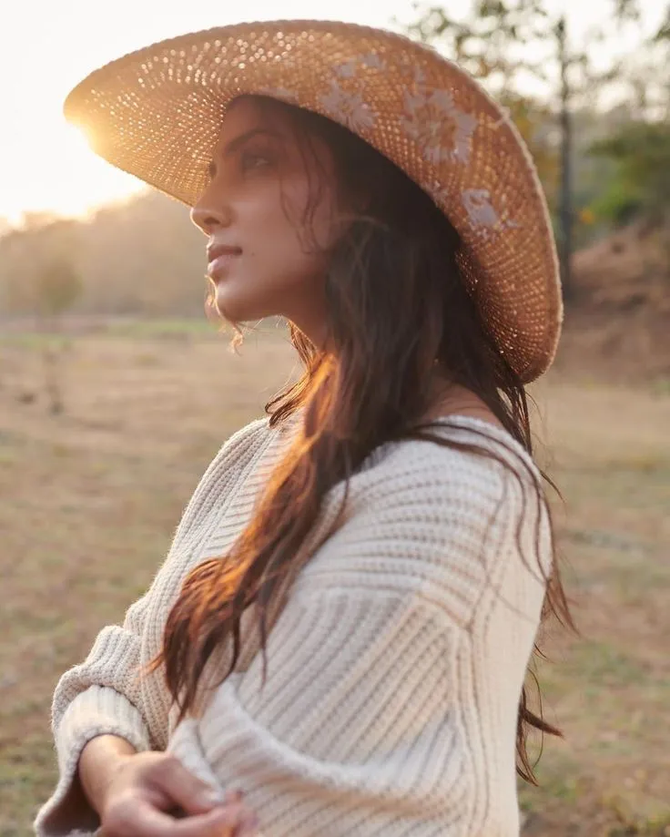 Stunning Malavika Mohanan Outdoor Pose Wearing Straw Hat
