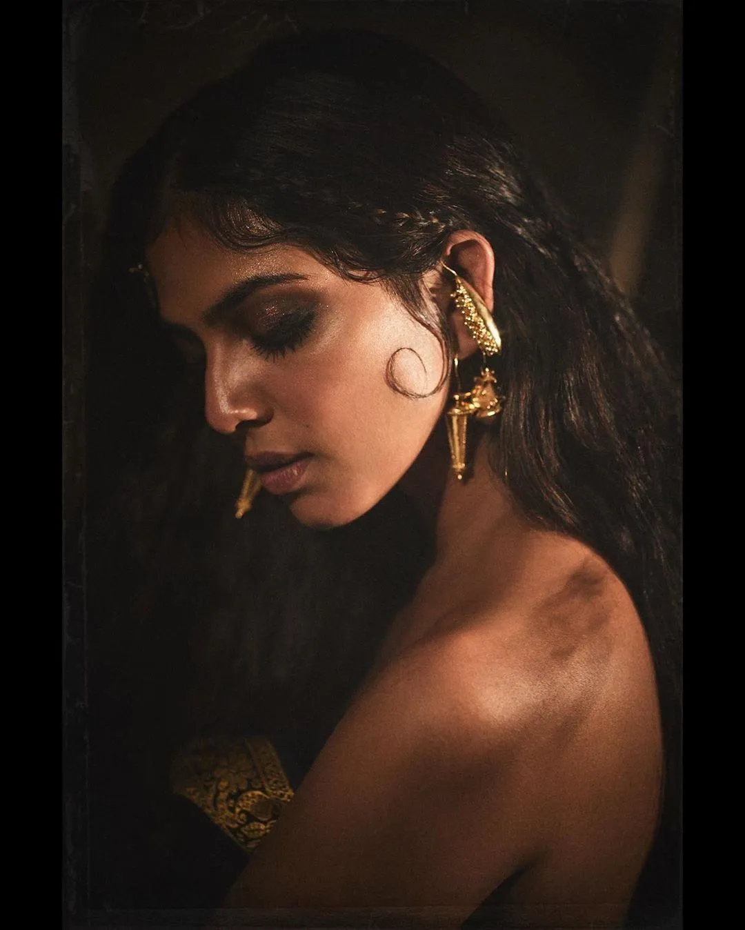 Sultry Malavika Mohanan in Dramatic Dark Background Pose