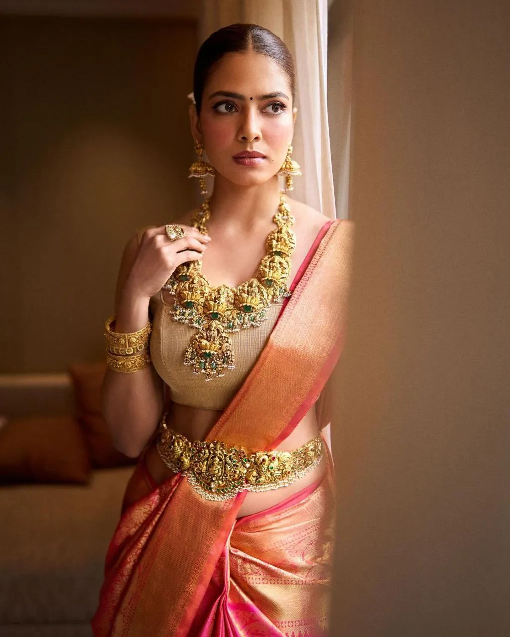 Sultry Malavika Mohanan in Golden Red Saree Sitting Look