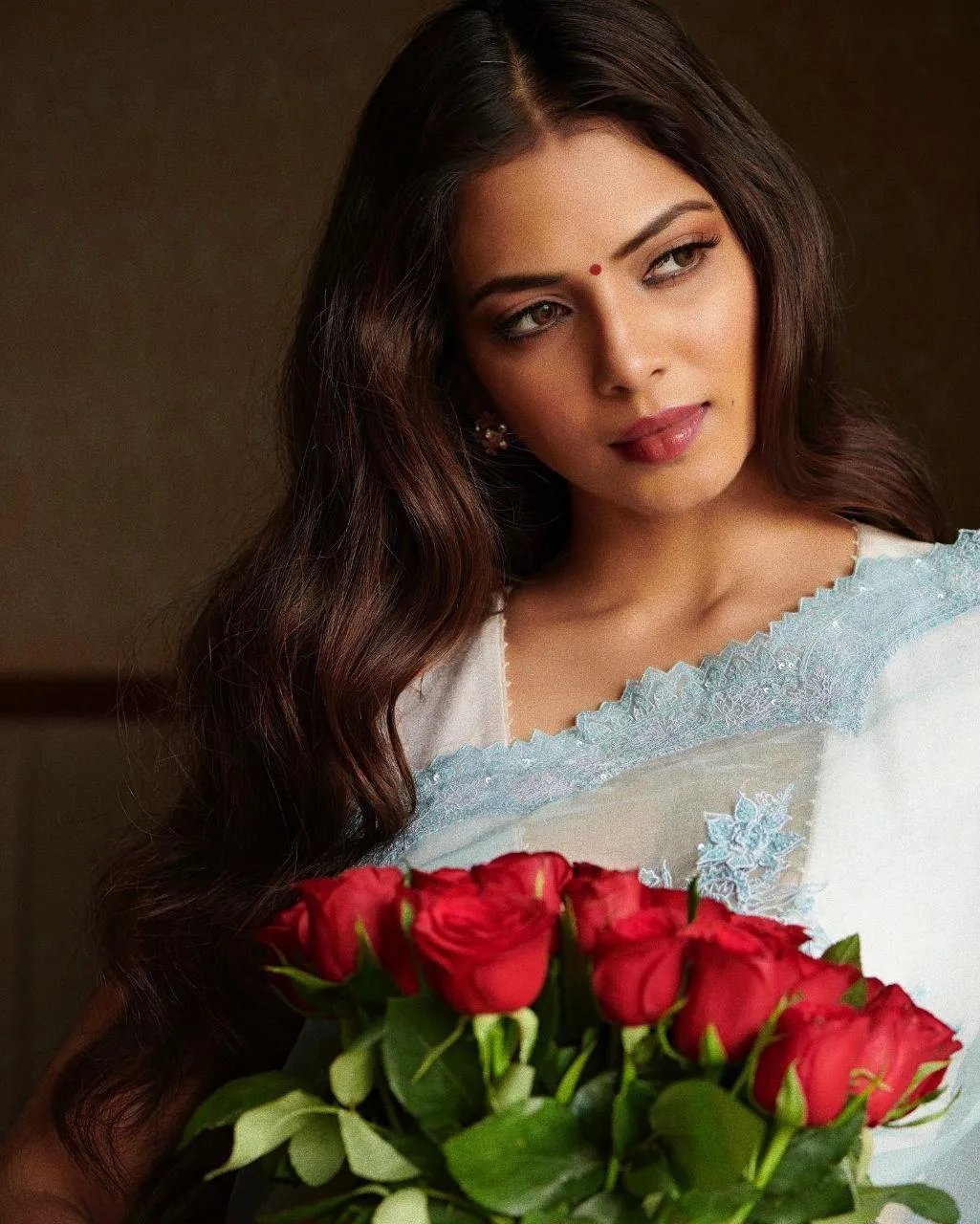 Sultry Malavika Mohanan in Light Saree Holding Red Roses