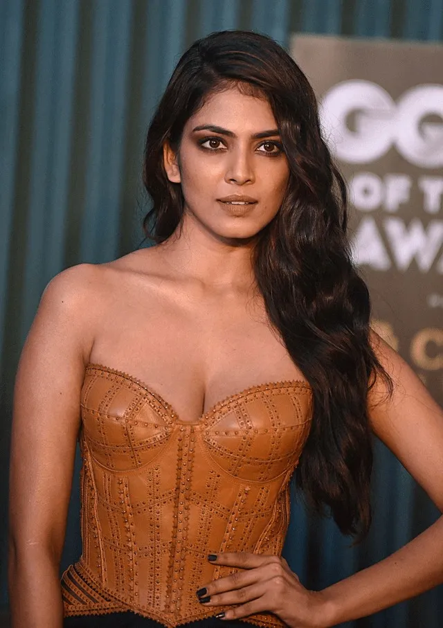 Sultry Malavika Mohanan in Orange Strapless Outfit Wallpaper