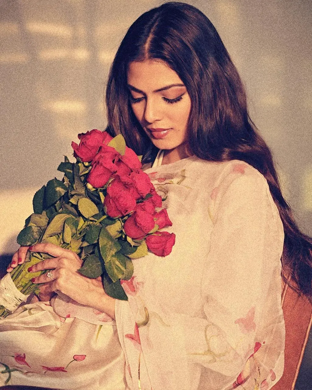 Sultry Malavika Mohanan in Red Outfit with Flowers Pose