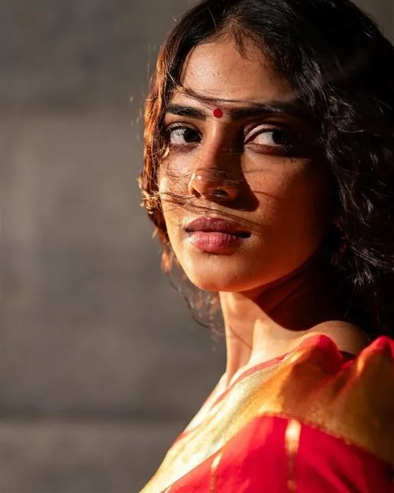 Sultry Malavika Mohanan in Red Saree with Intense Gaze Image