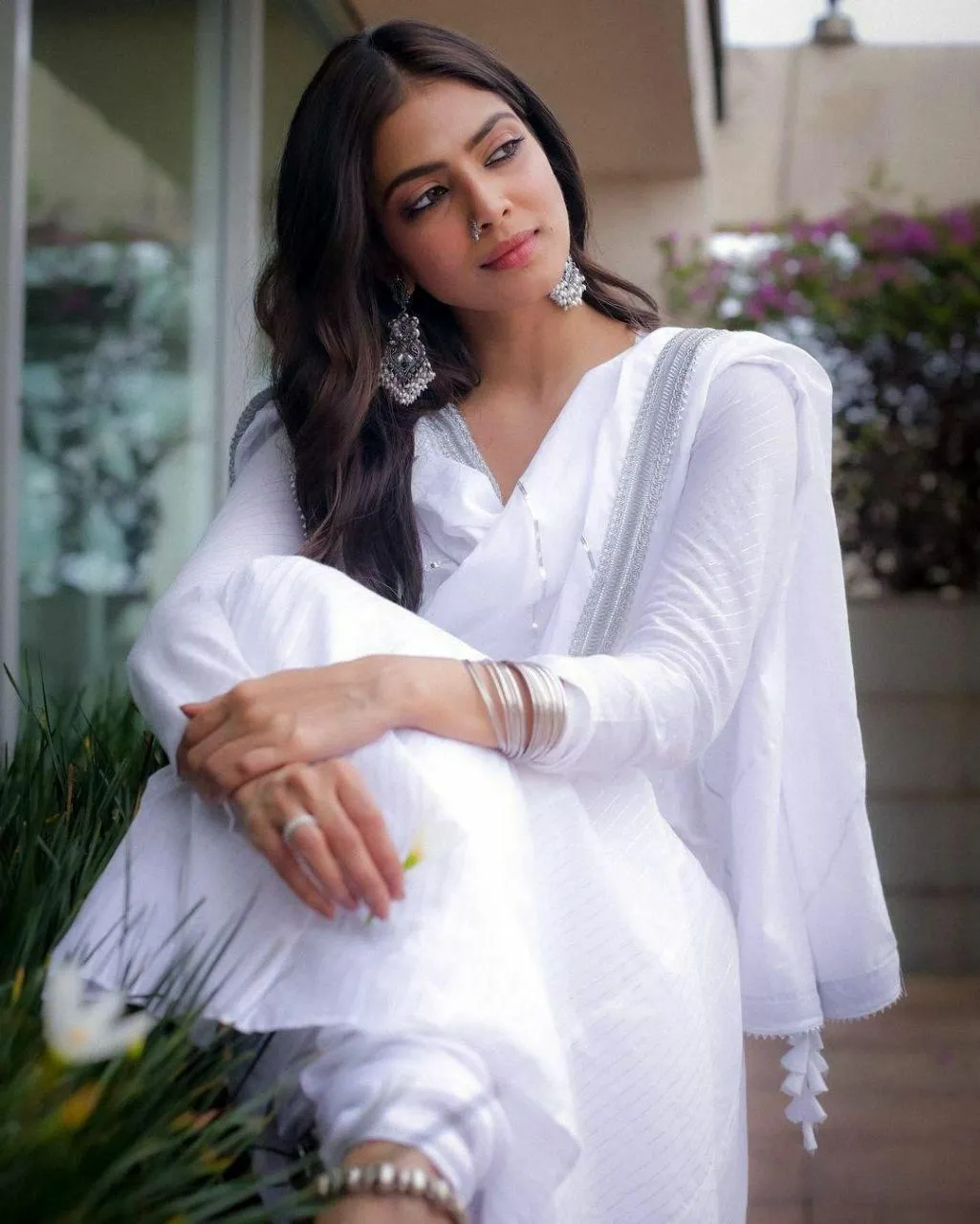 Sultry Malavika Mohanan in White Short Dress Near Flowers