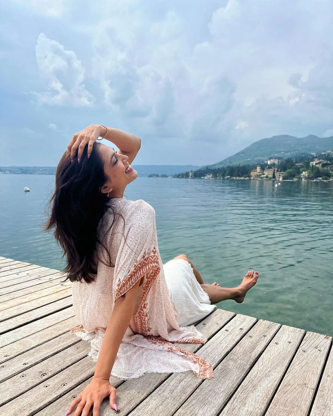 Sultry Malavika Mohanan Sitting on Wooden Deck Near Sea