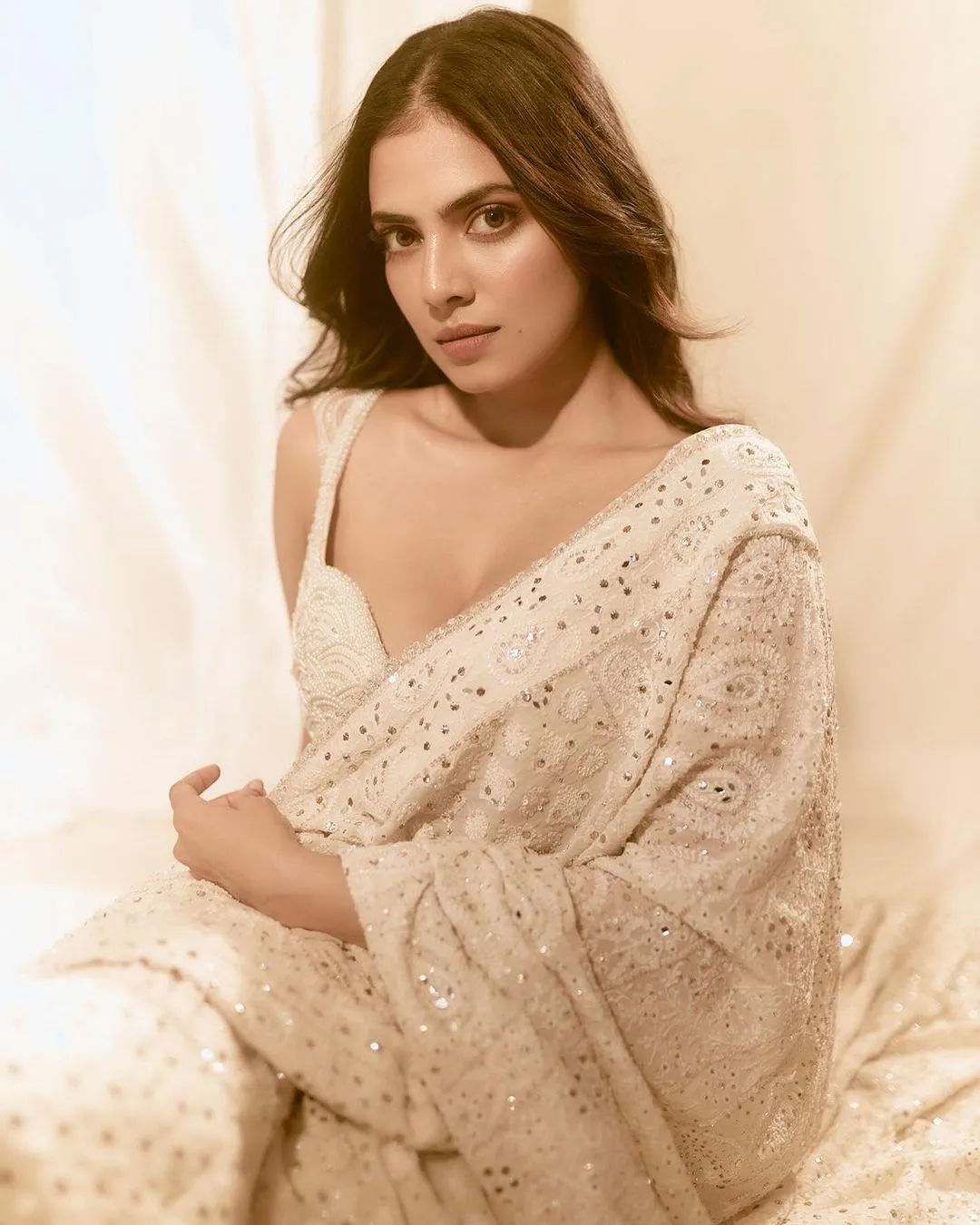 Tempting Malavika Mohanan in Cream Saree with Bold Look