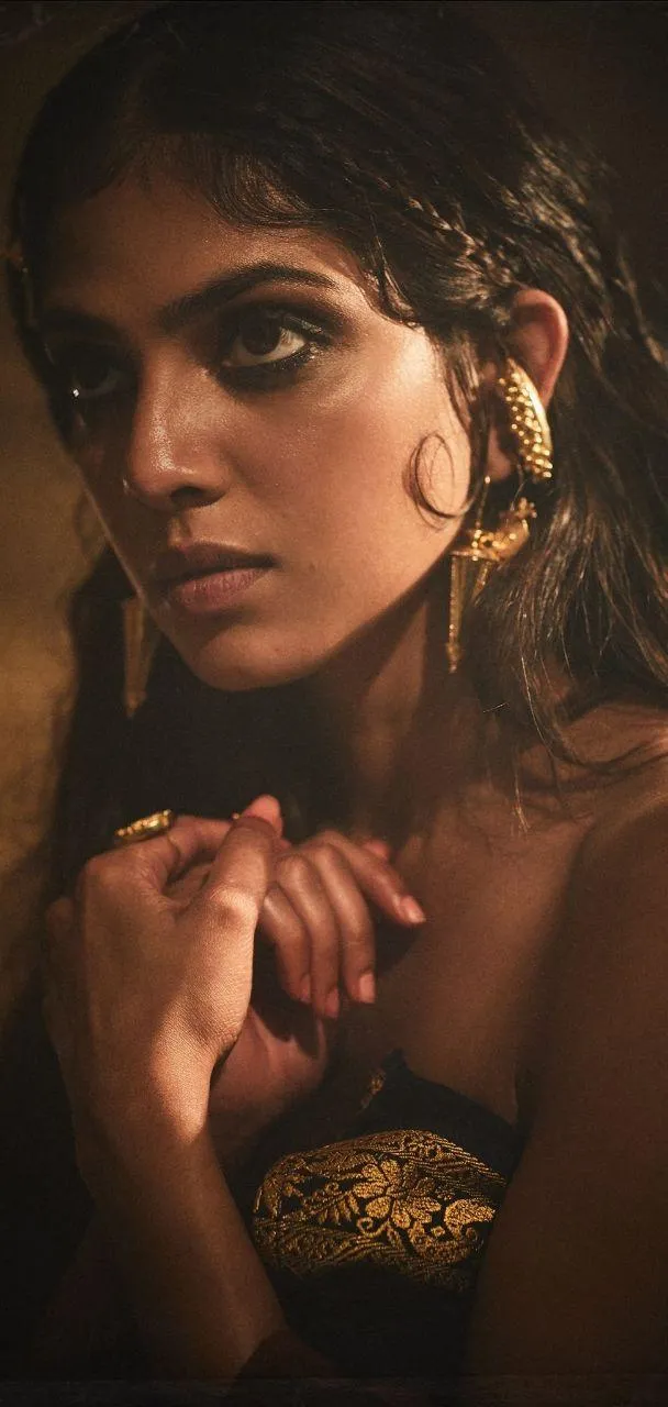 Tempting Malavika Mohanan in Golden Dress Intense Glance