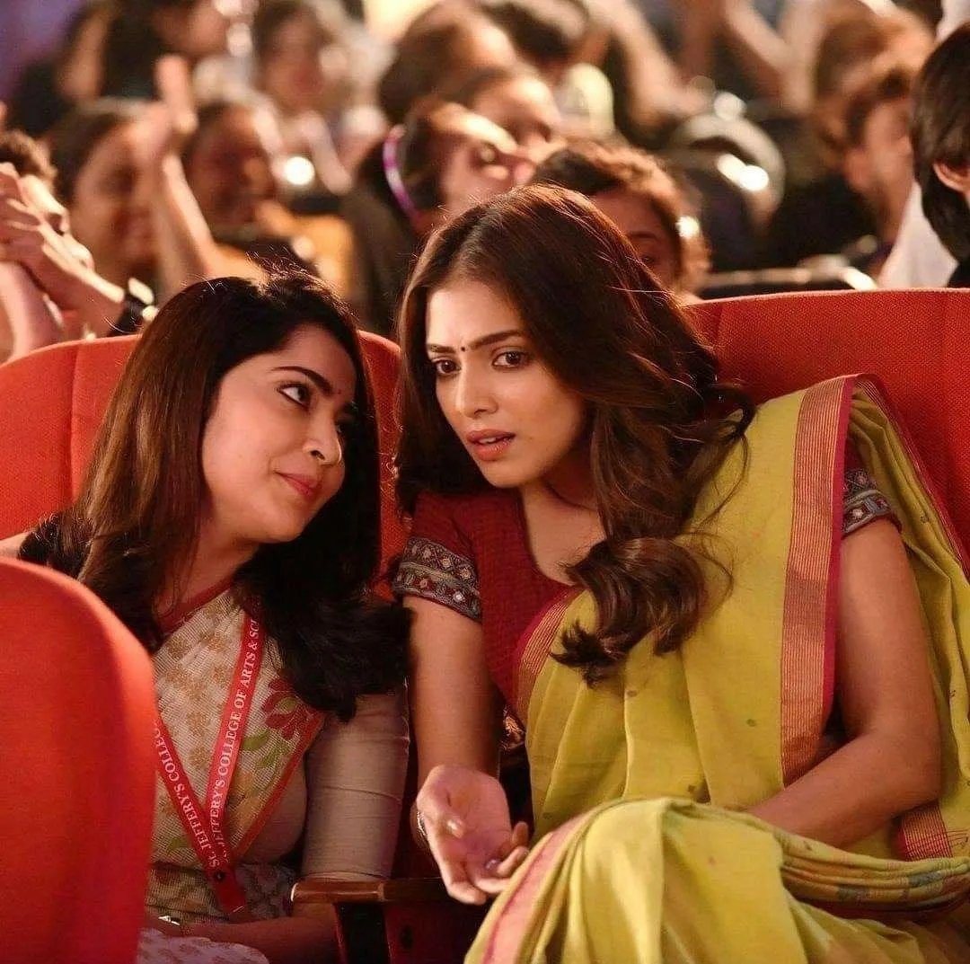 Tempting Malavika Mohanan in Green Saree Sitting in Crowd