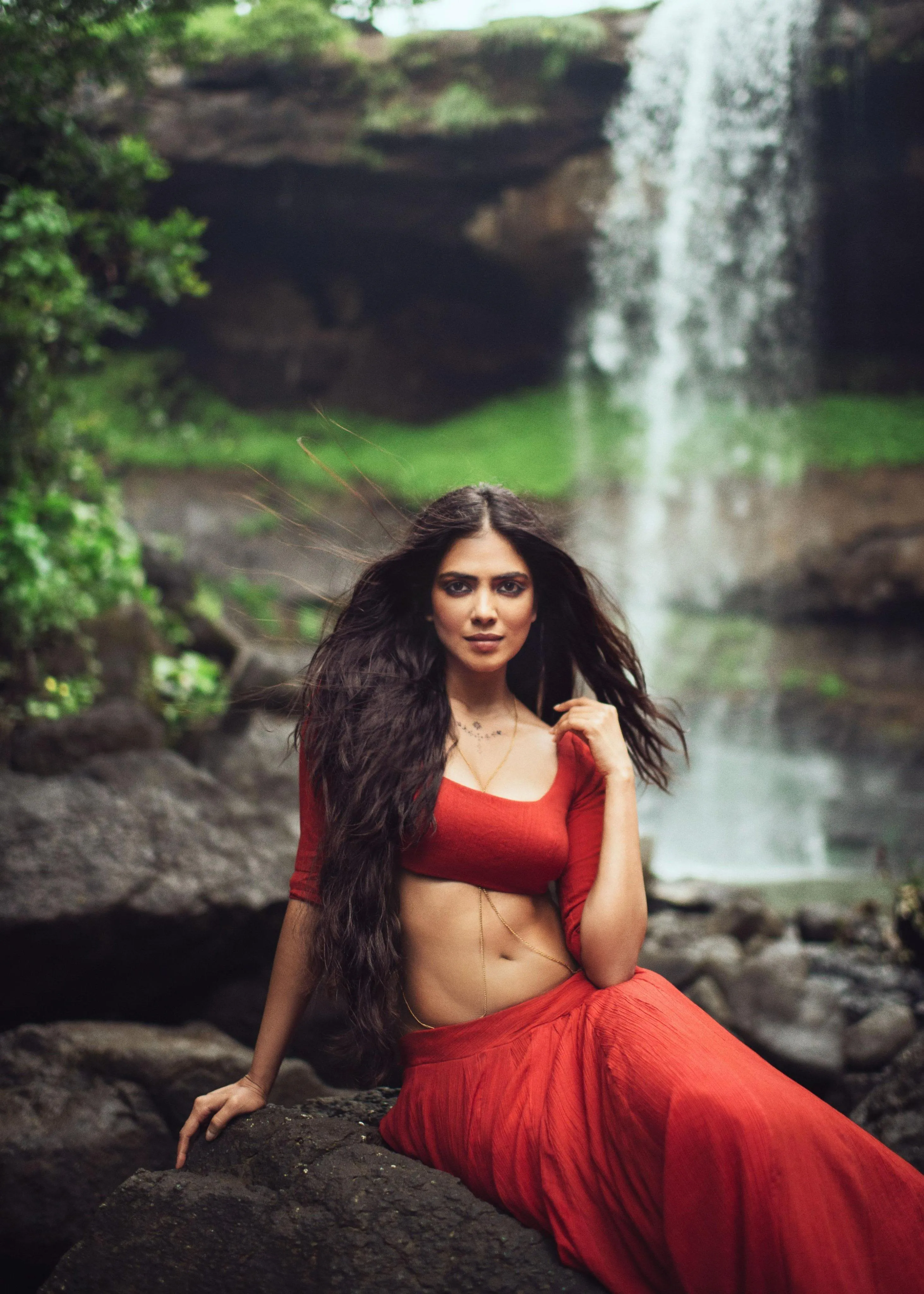 Tempting Malavika Mohanan in Red Saree Beside Waterfall