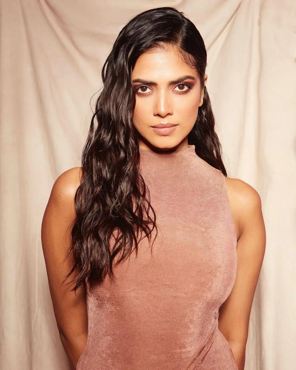 Tempting Malavika Mohanan in Sleeveless Brown Dress Posing