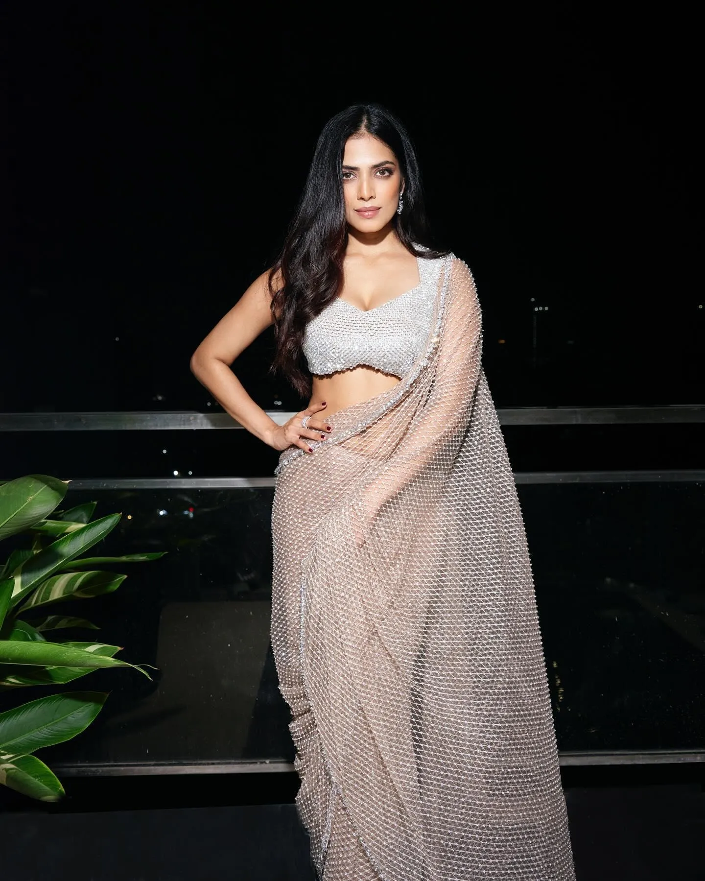 Tempting Malavika Mohanan in White Saree with Elegant Pose