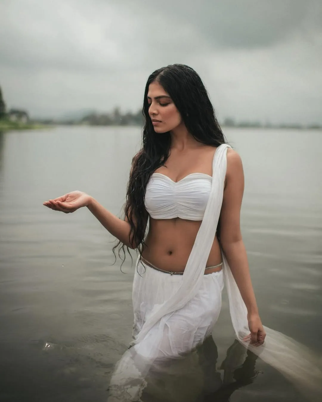 Tempting Malavika Mohanan Walks in White Near Water Image