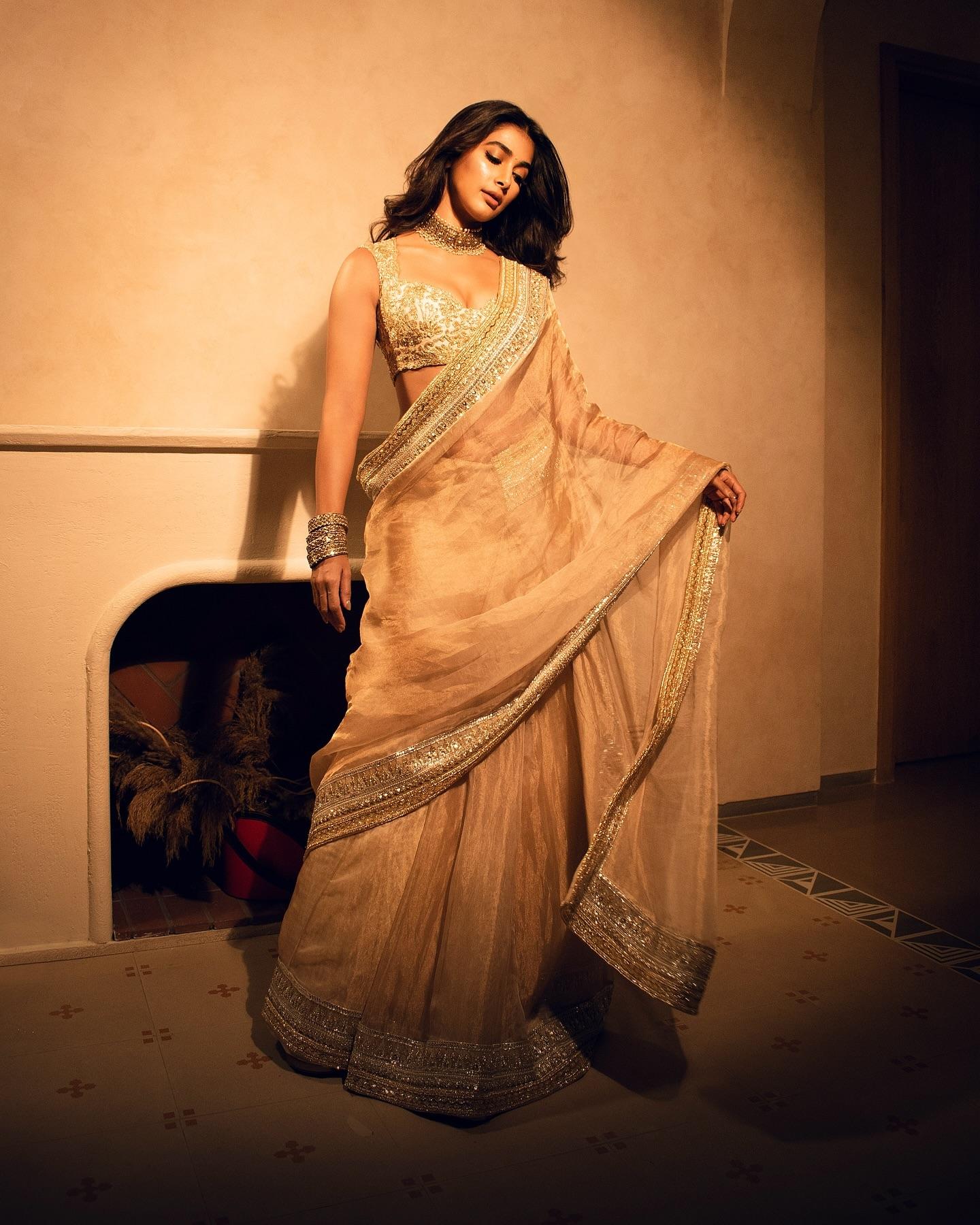 Elegant Pooja Hegde in Saree Posing Beside the Fireplace
