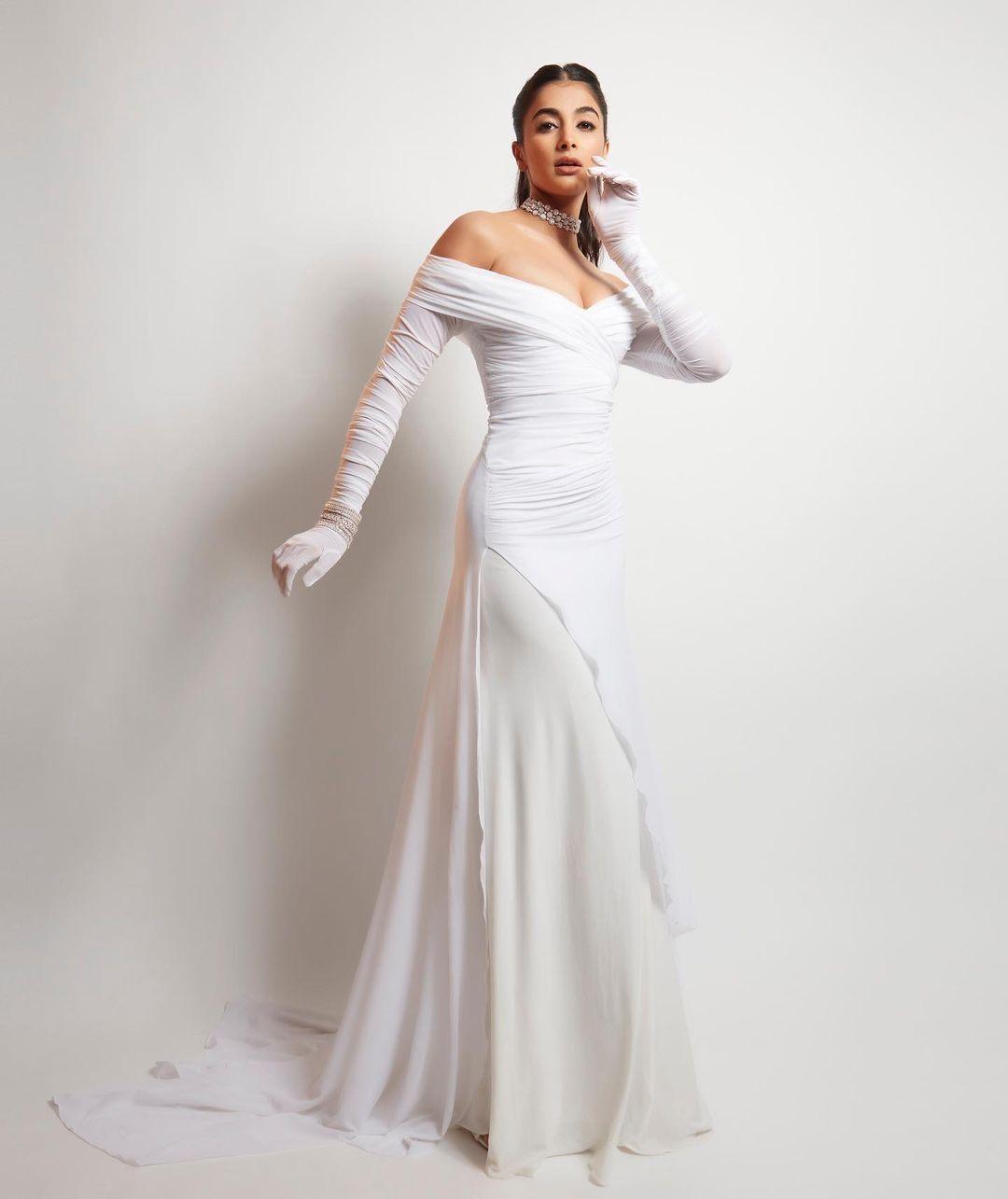 Glamorous Pose By Pooja Hegde in Full Length White Gown
