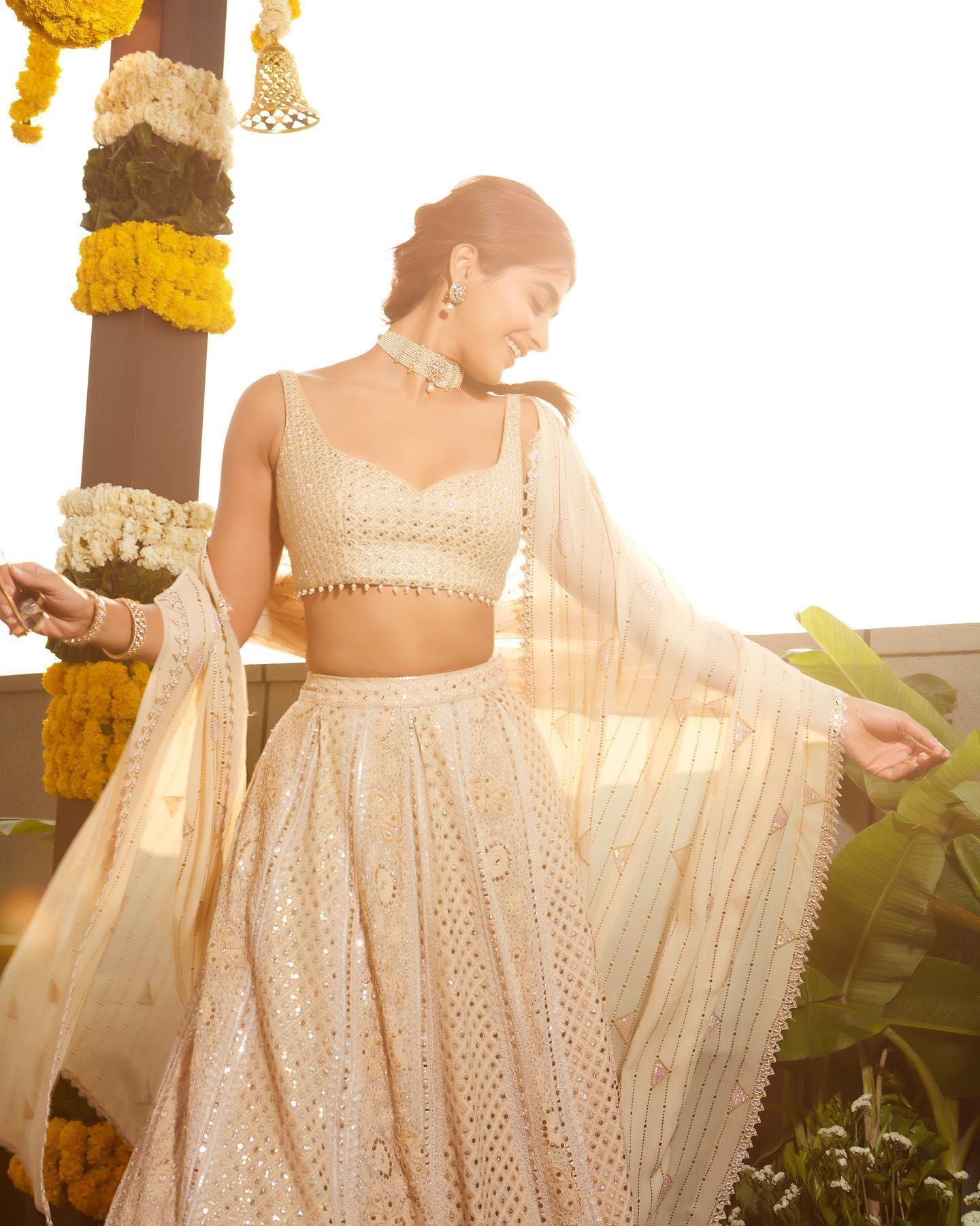 Pooja Hegde Dancing in Cream Lehenga Under Sunlight Image