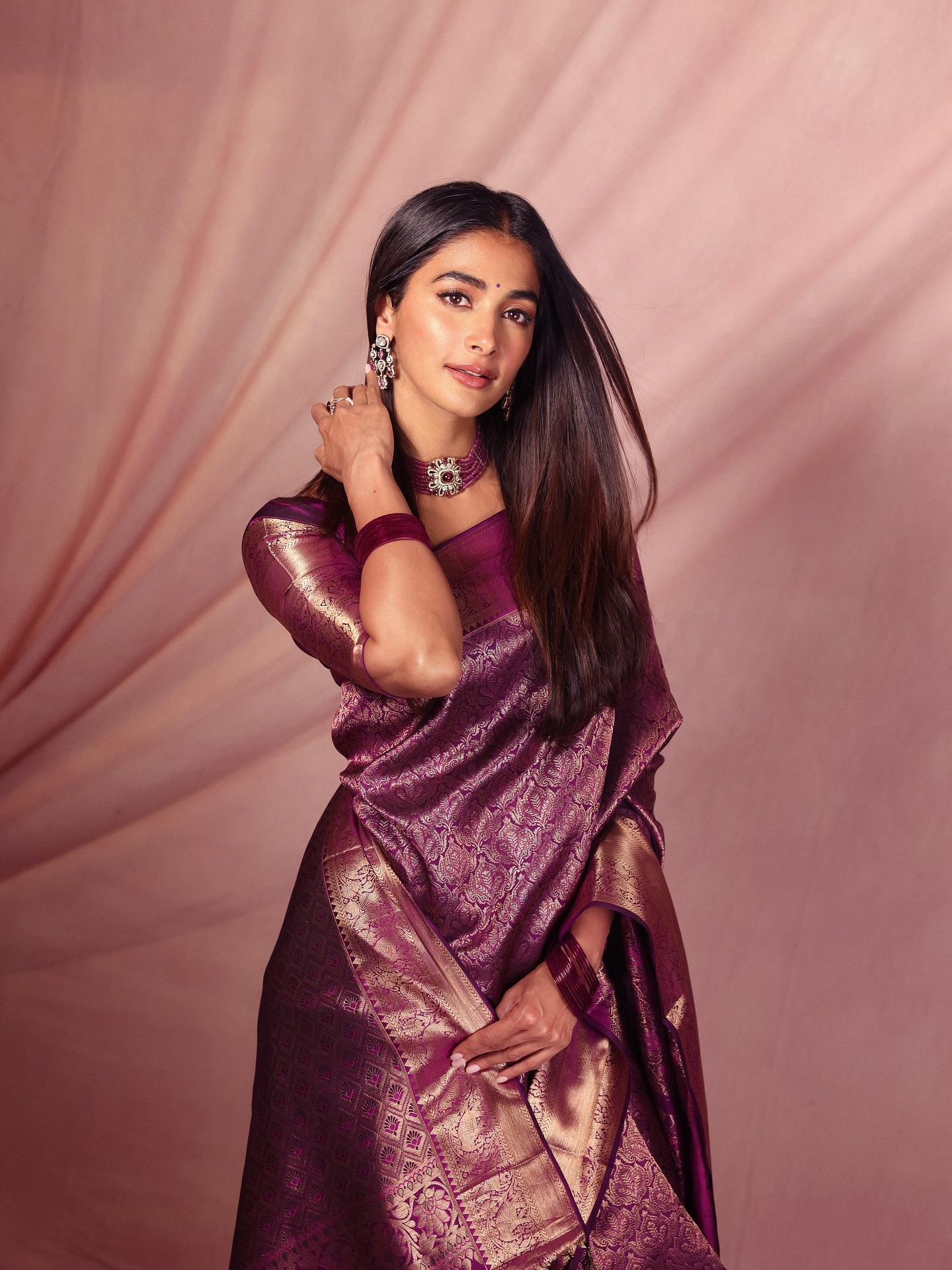 Pooja Hegde Draped in Maroon Saree Against Pink Wall