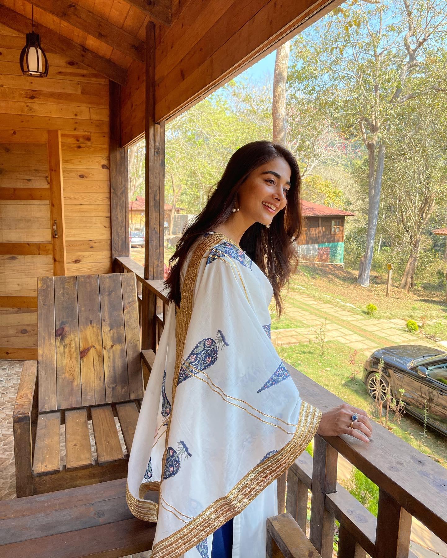 Pooja Hegde Enjoys Balcony View in Cozy White Outfit